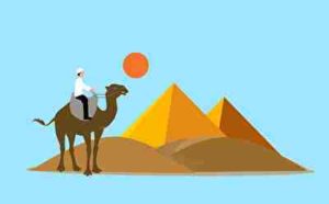 砂漠を歩くラクダと男性
